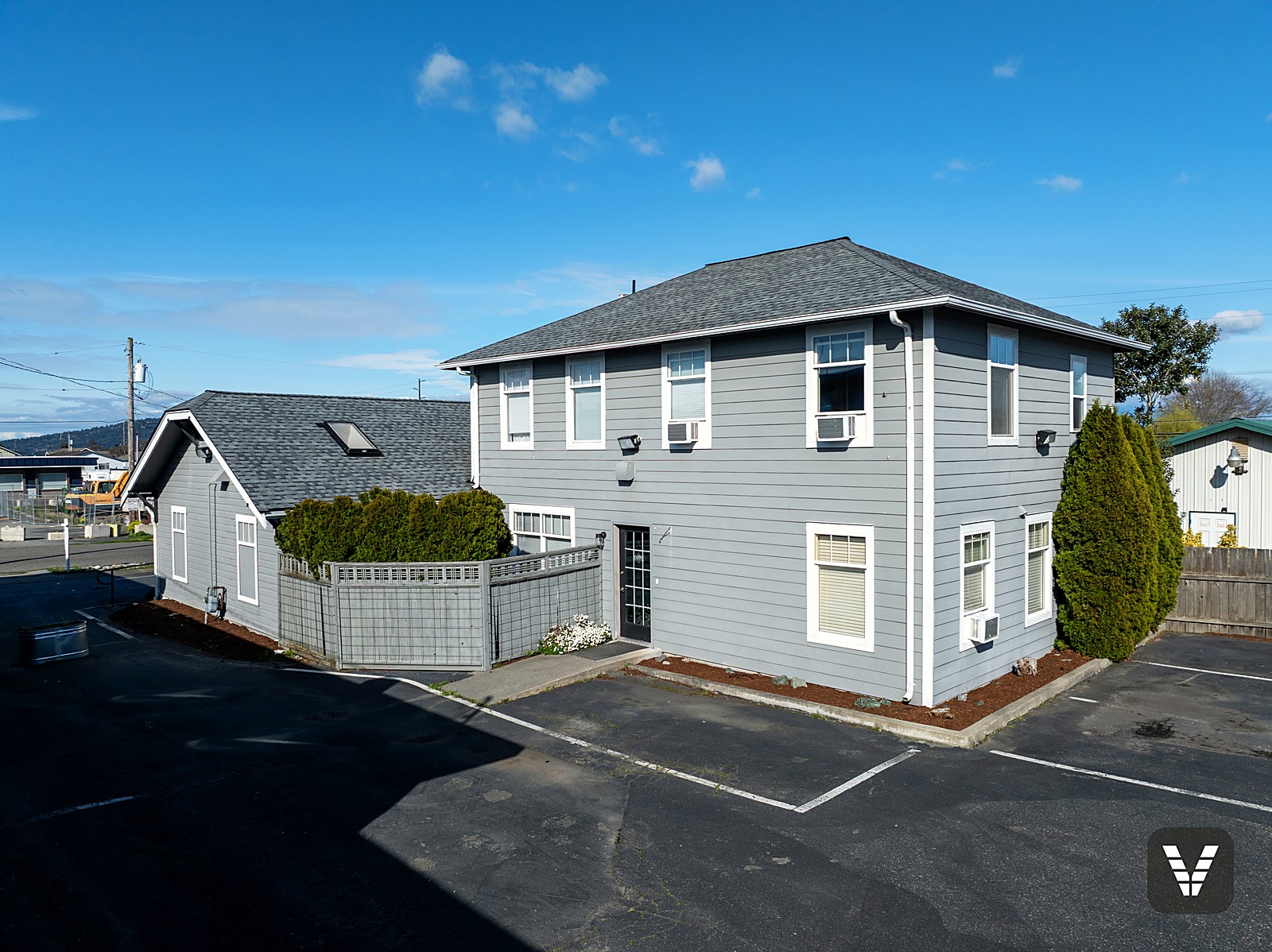 Before the renovation — both showroom buildings at 911 29th Street, Anacortes, exactly as purchased