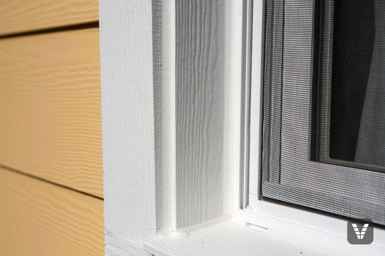 Window trim up close — Cedarmill-textured surrounds and a new sill line against the yellow lap