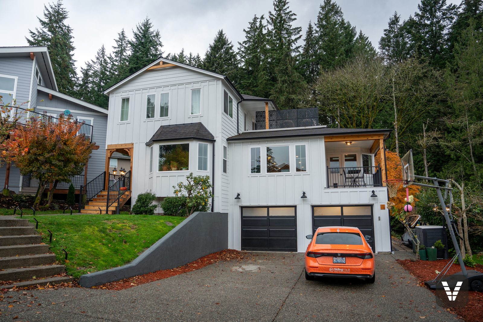 Completed Arctic White James Hardie board-and-batten remodel above Lake Whatcom in Bellingham, WA