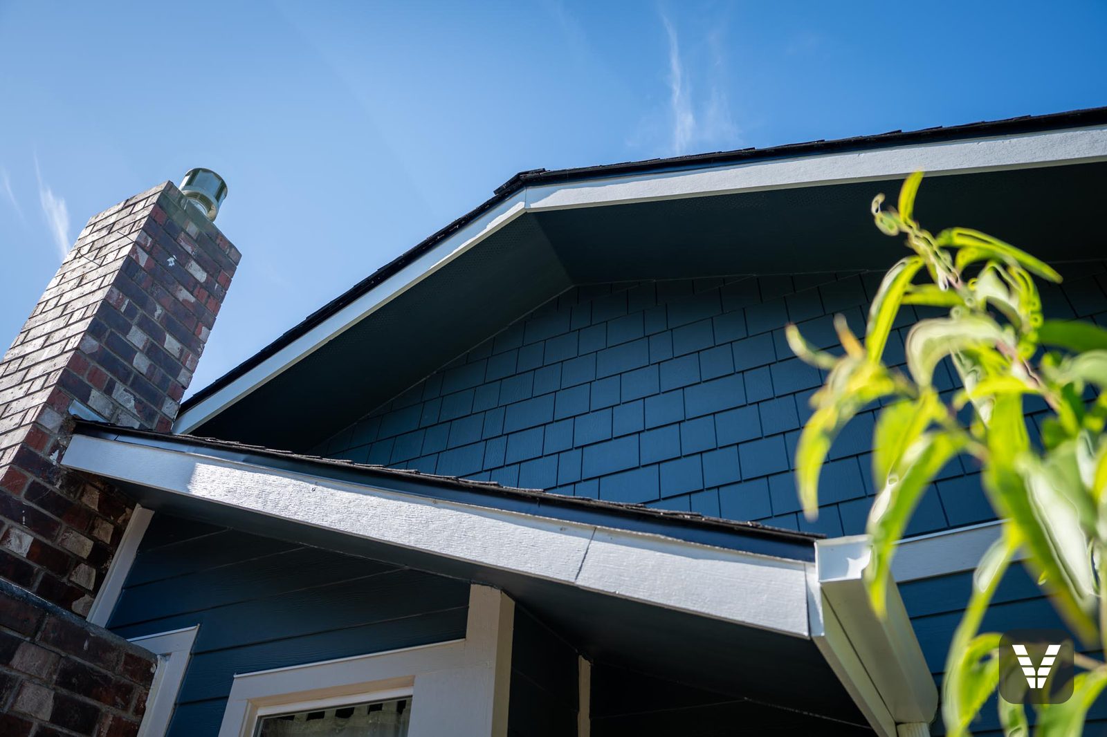 Gable peak in shingle beside the original brick chimney — Siding & Window Vault project in Bellingham, WA