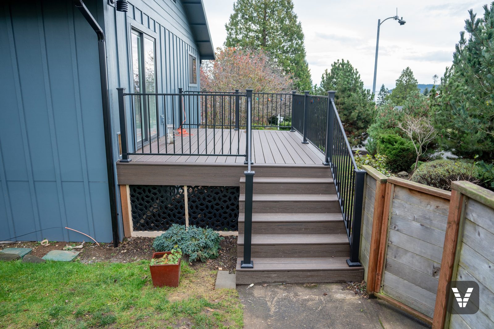 Trex Transcend stairs with RDI MetalWorks steel railing and black lattice skirting