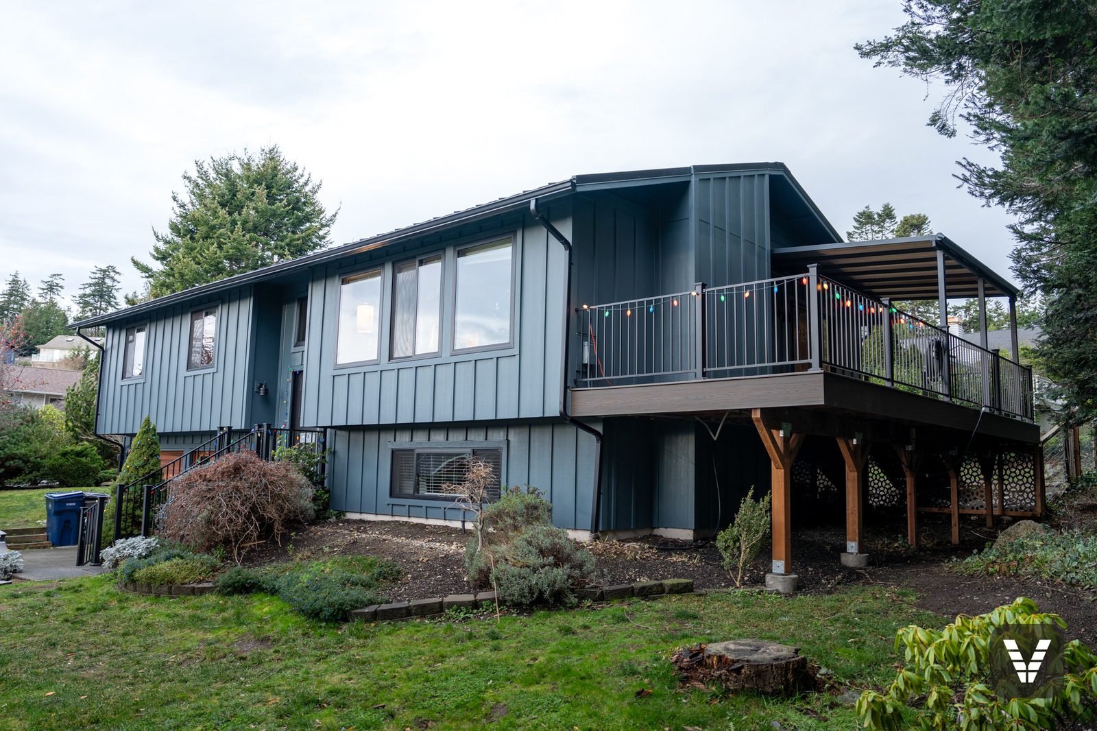 Front elevation with new Evening Blue Hardie siding and covered Trex deck