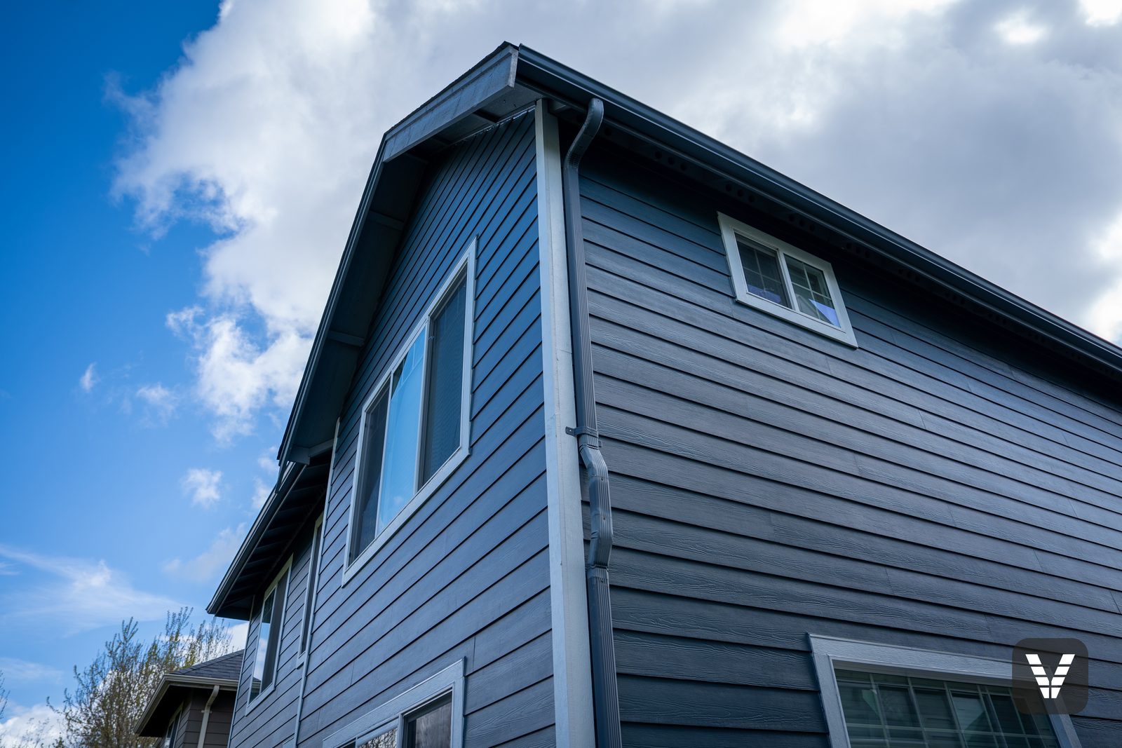 Gable peak and gutter line above the new Cedarmill lap — Siding & Window Vault project in Ferndale, WA