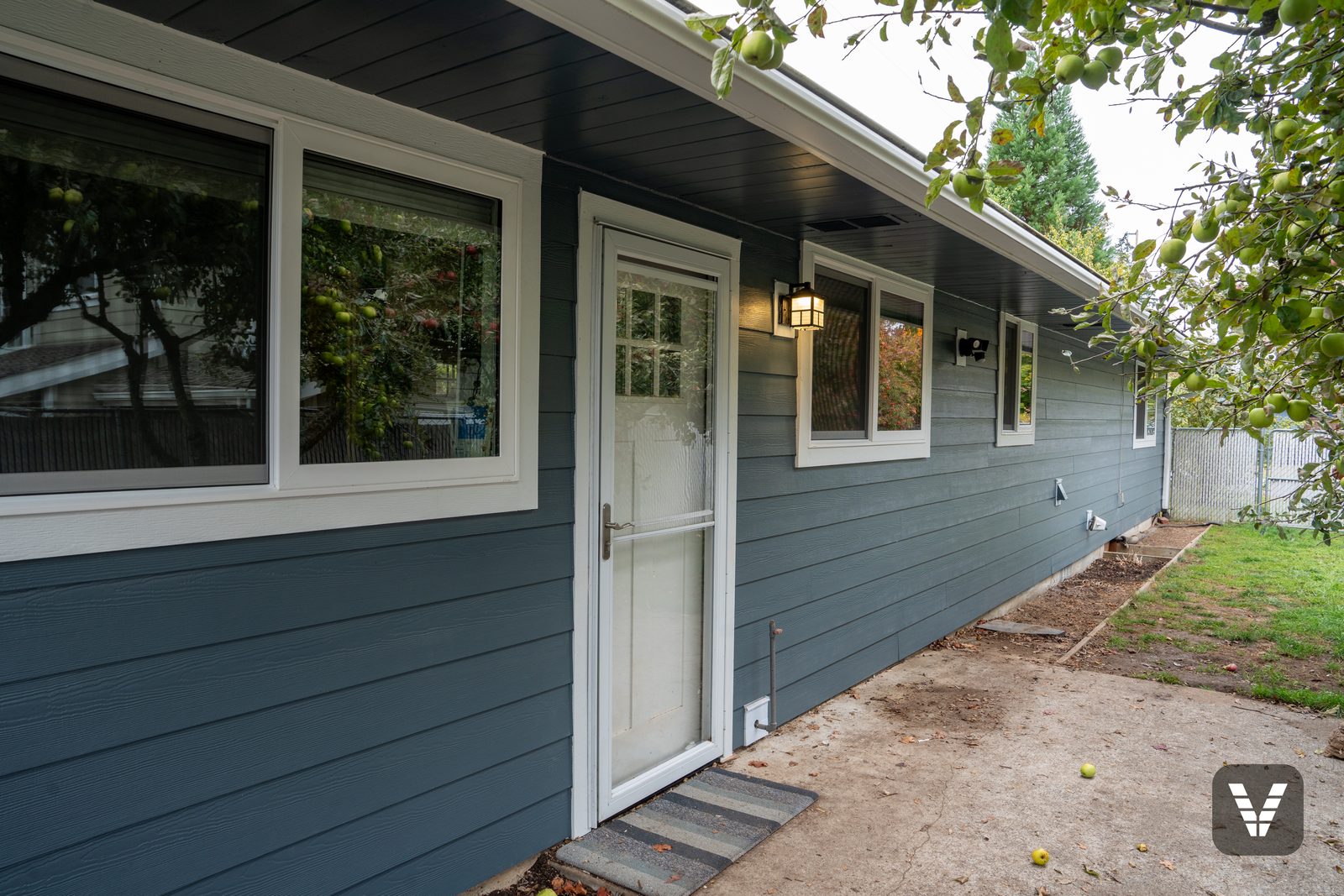 The back wall — new windows on both sides of the back door, each trimmed in Arctic White HardieTrim