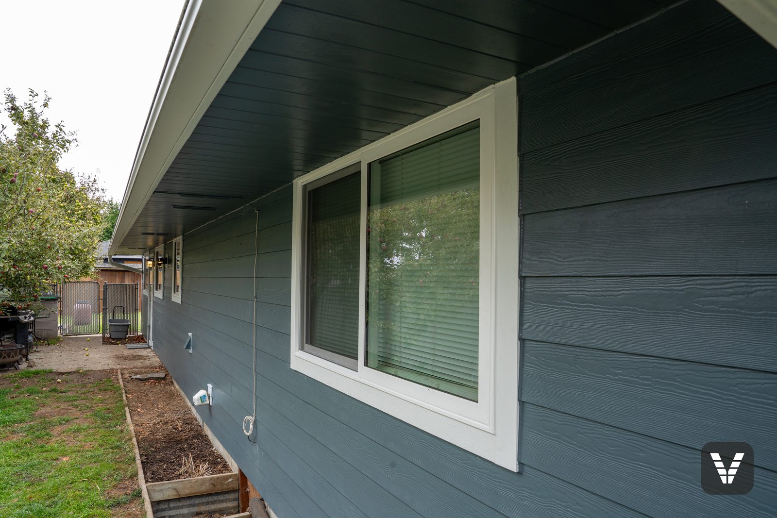 A new sliding window on the back wall under the freshly painted soffit