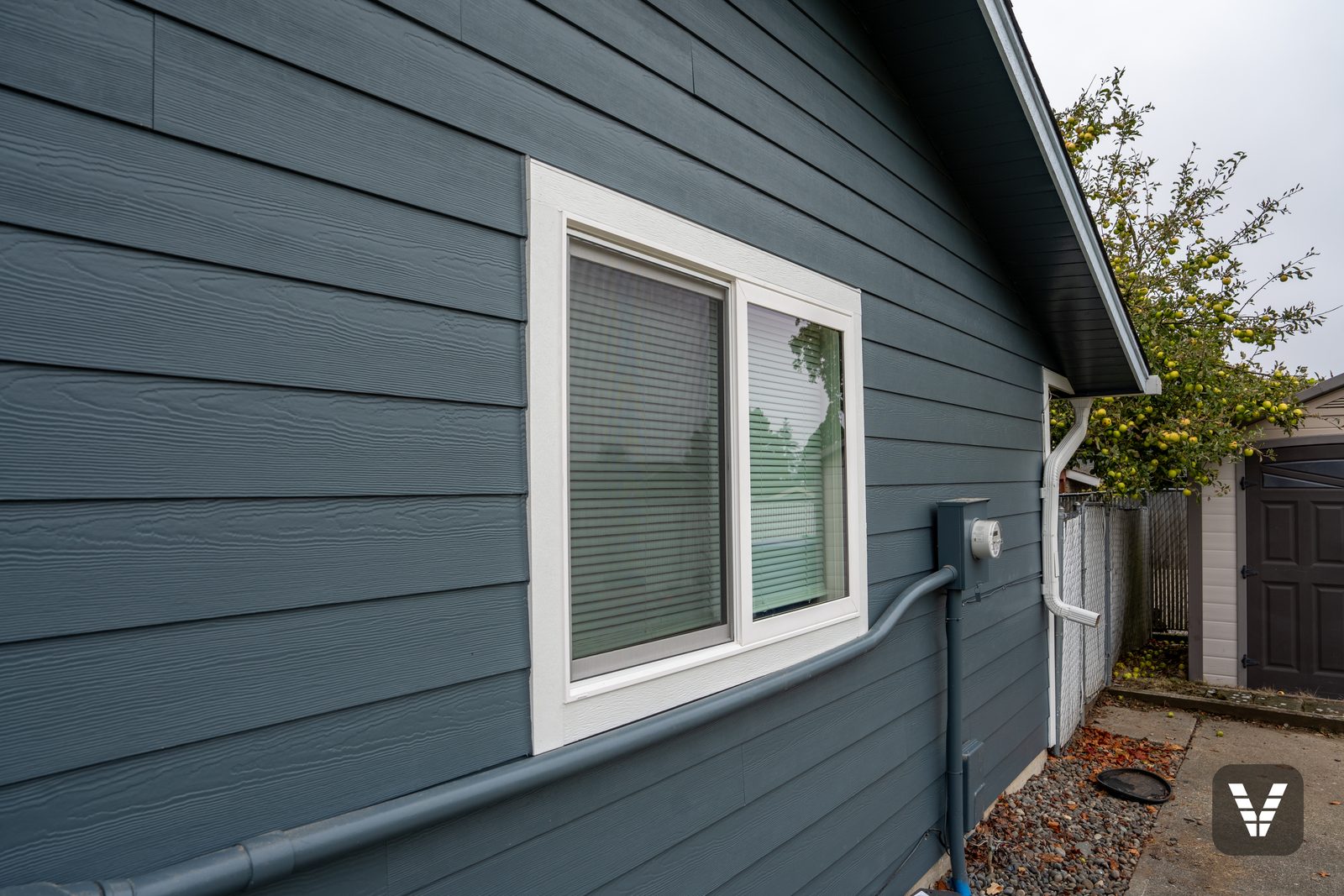 The new gable-wall window, with the conduit below it painted to match the siding