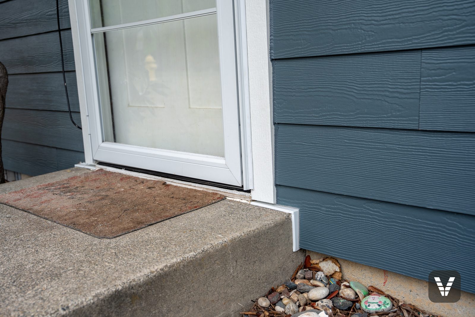 The front step after the re-side — new plank and trim where the old siding had cracked