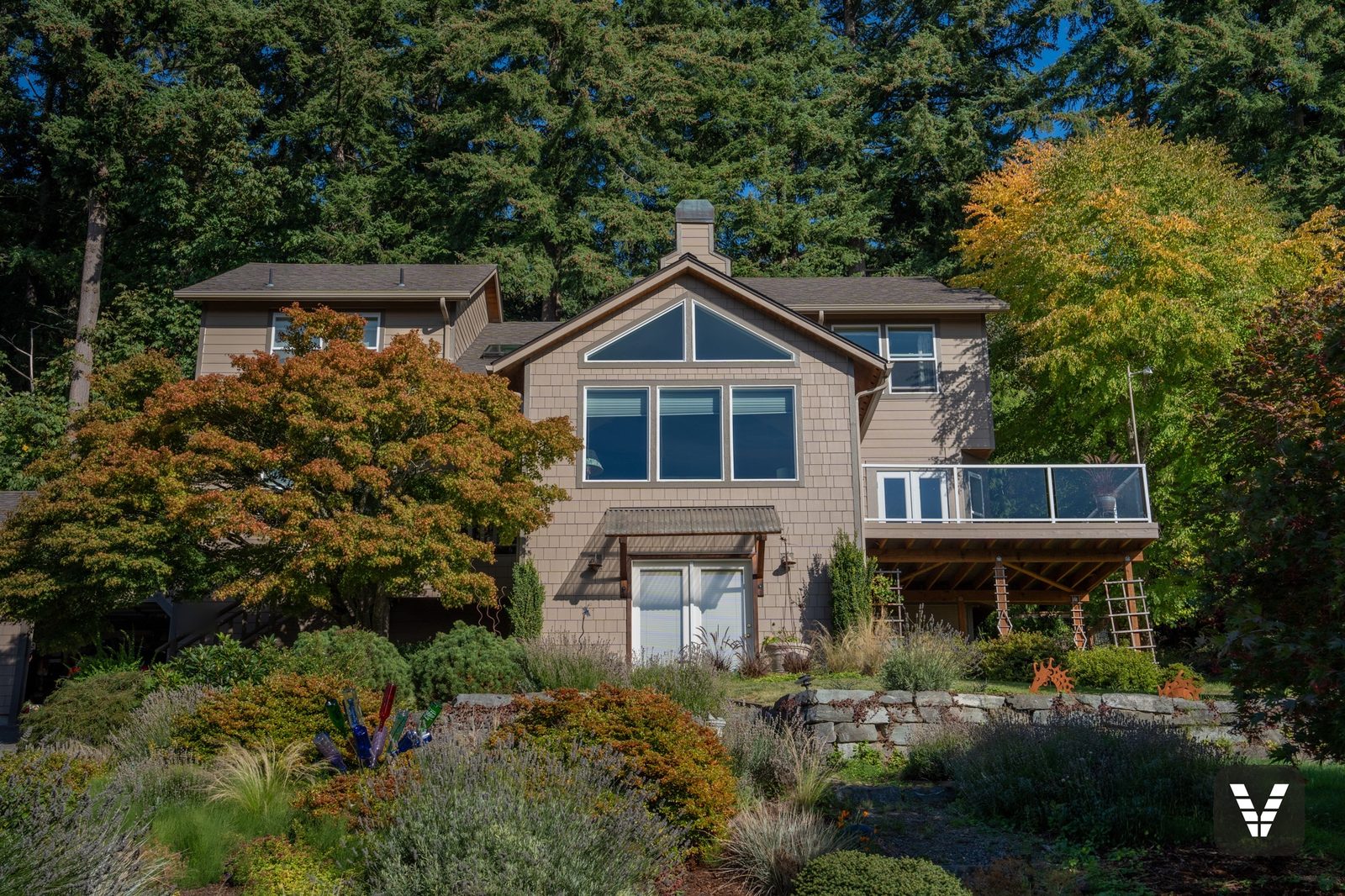 Completed Khaki Brown James Hardie shingle and lap re-side with Timber Bark trim on a forested Bellingham home