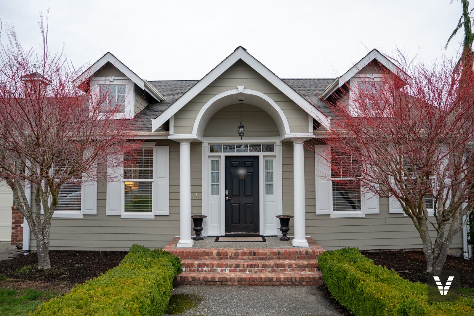 Finished entry — arched portico with continuous heat-formed white trim over Monterey Taupe HardiePlank in Anacortes, WA