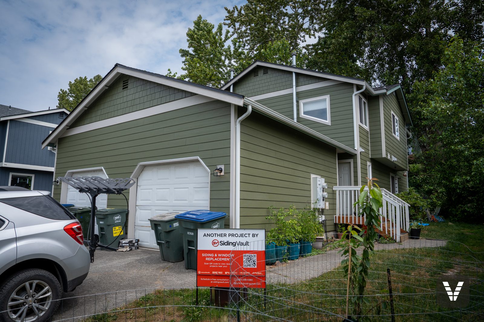 The Bellingham duplex after its re-side — Mountain Sage James Hardie lap with shingle gable accents and Cobble Stone trim