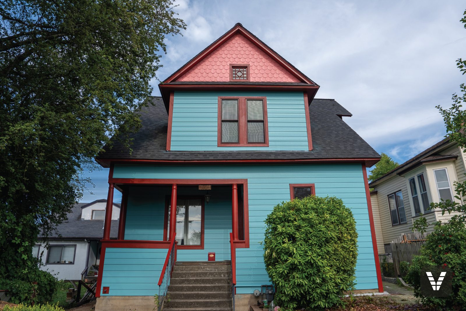 A Bellingham Victorian re-sided in primed James Hardie lap siding and painted on site in turquoise with crimson trim and coral gable shingles