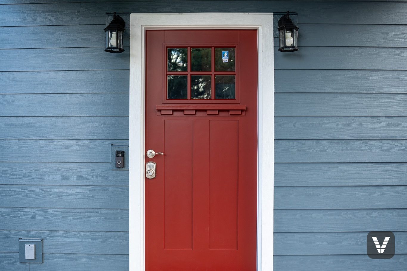 The Codel entry door framed by Evening Blue lap and wrapped porch posts