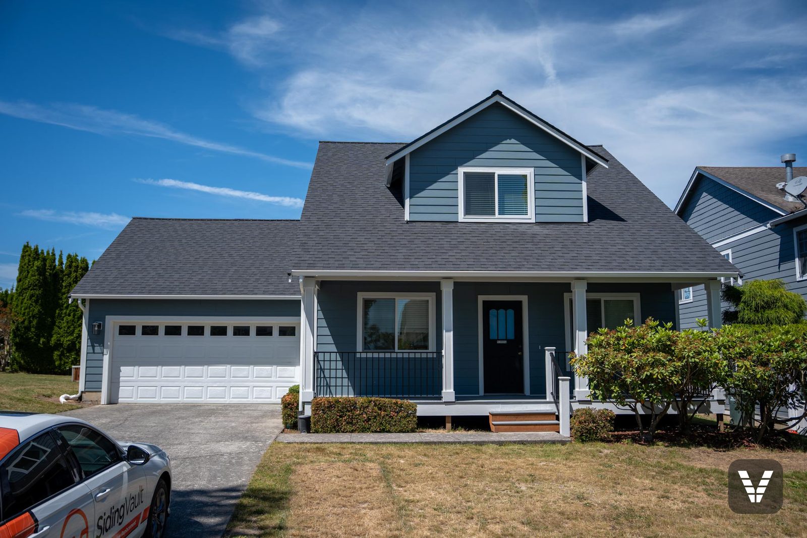 The finished front straight on — Boothbay Blue lap, new windows, and the rebuilt porch — Siding & Window Vault project in Ferndale, WA