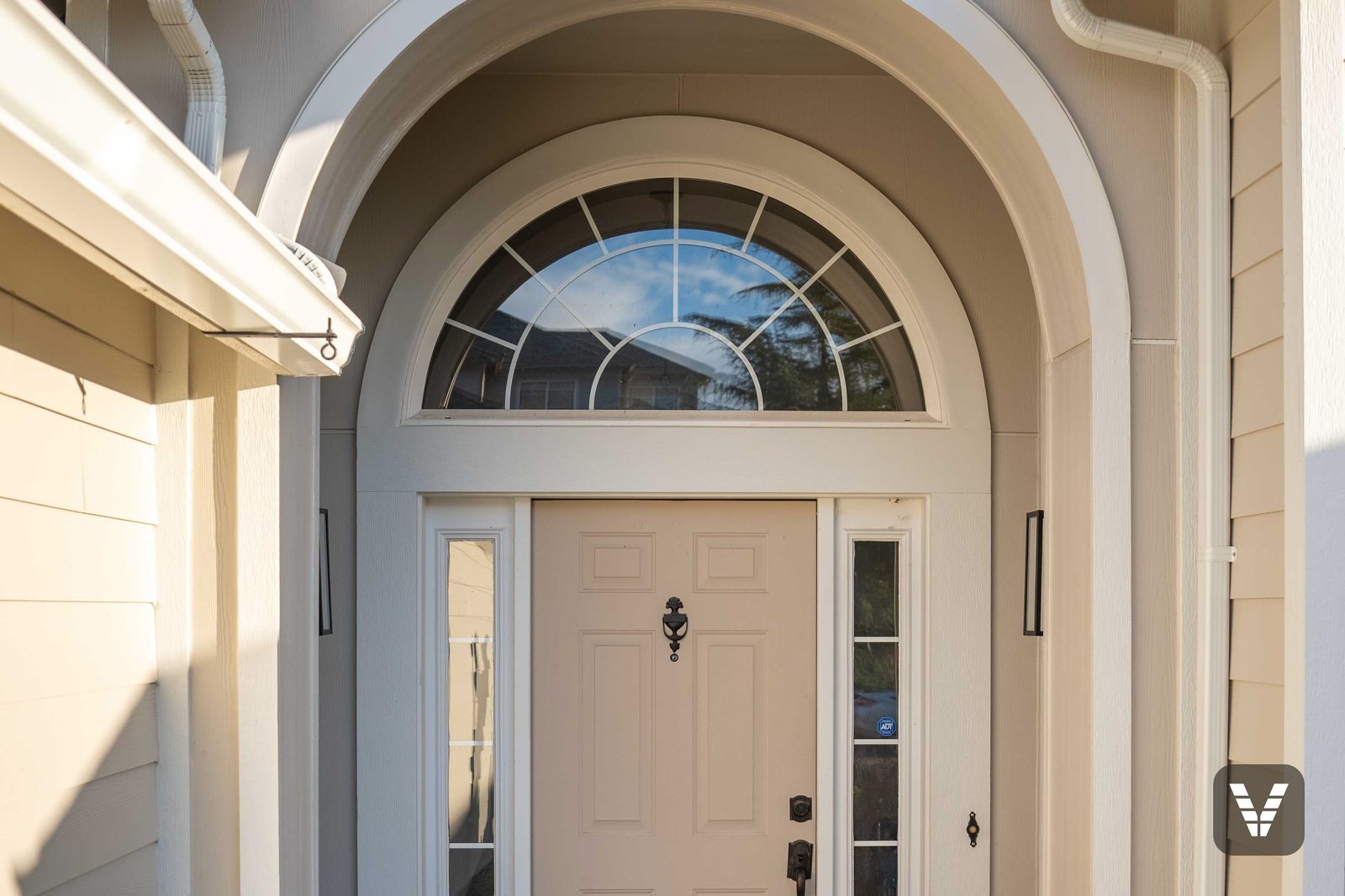 The entry alcove — arched transom framed in Arctic White trim, curves formed without seams