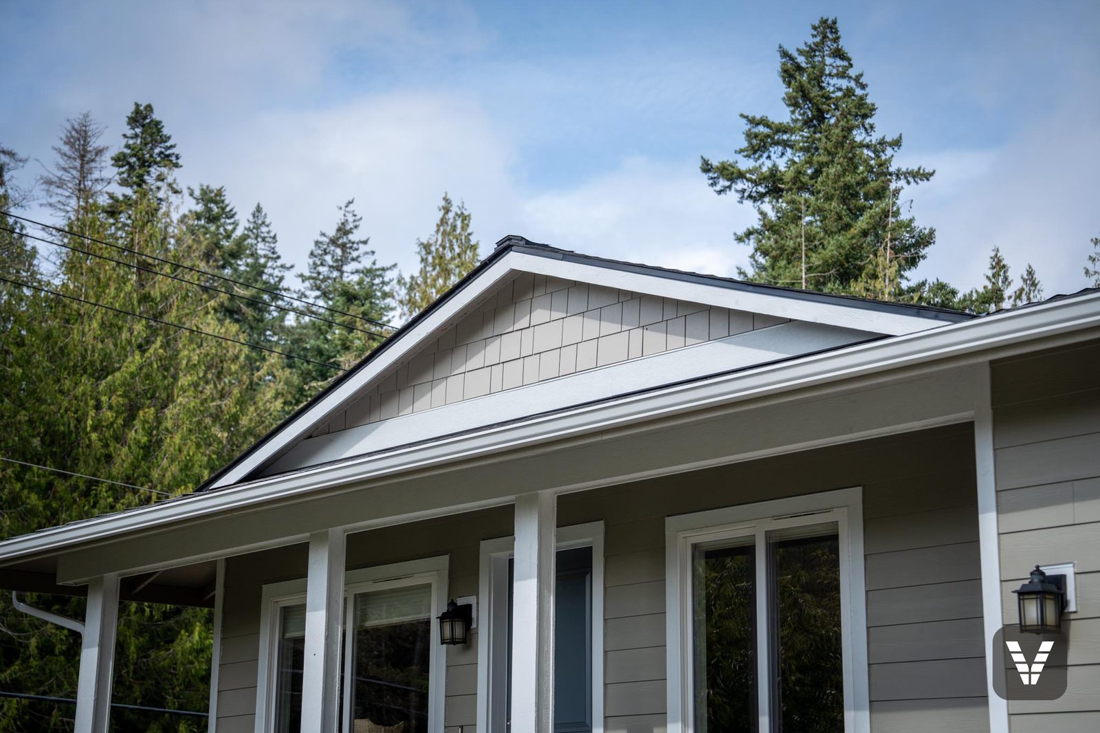 The porch gable — Cobblestone shingle above an upper beam wrapped in HardieTrim, the upgrade Michael suggested for the entry
