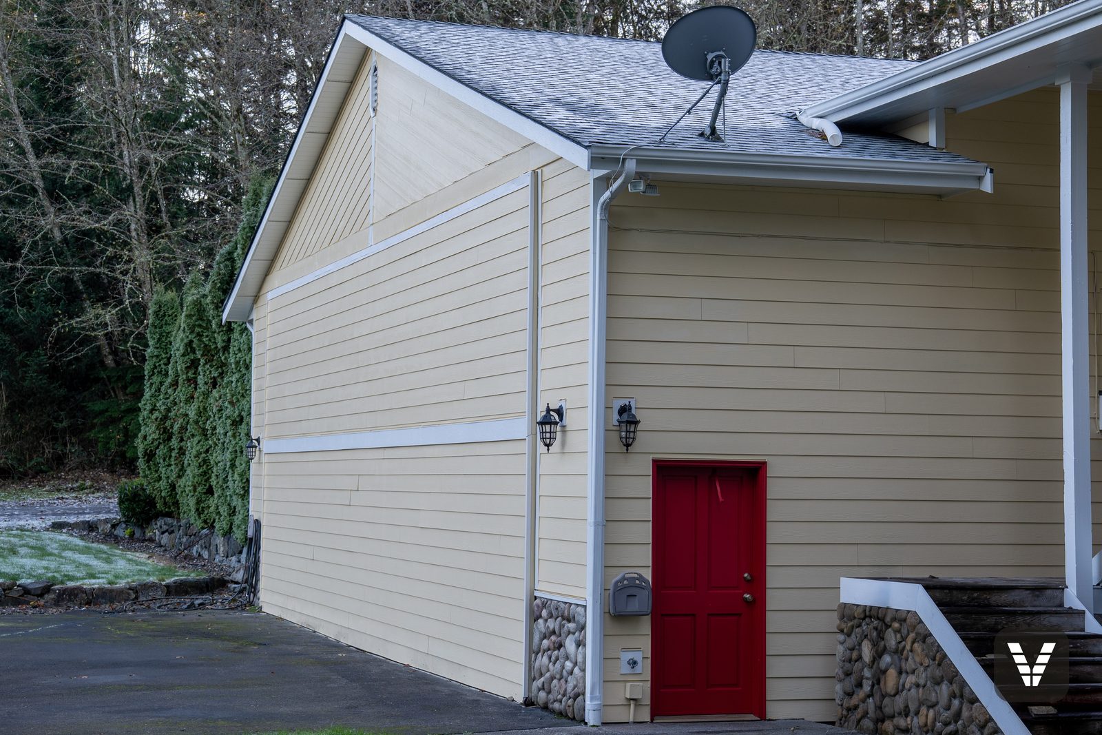Red side door, lantern lights, and the new GAF roof above — Siding & Window Vault project in Lake Stevens, WA